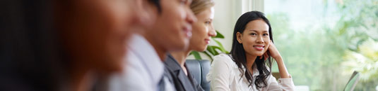 An image showing a young woman in a meeting
