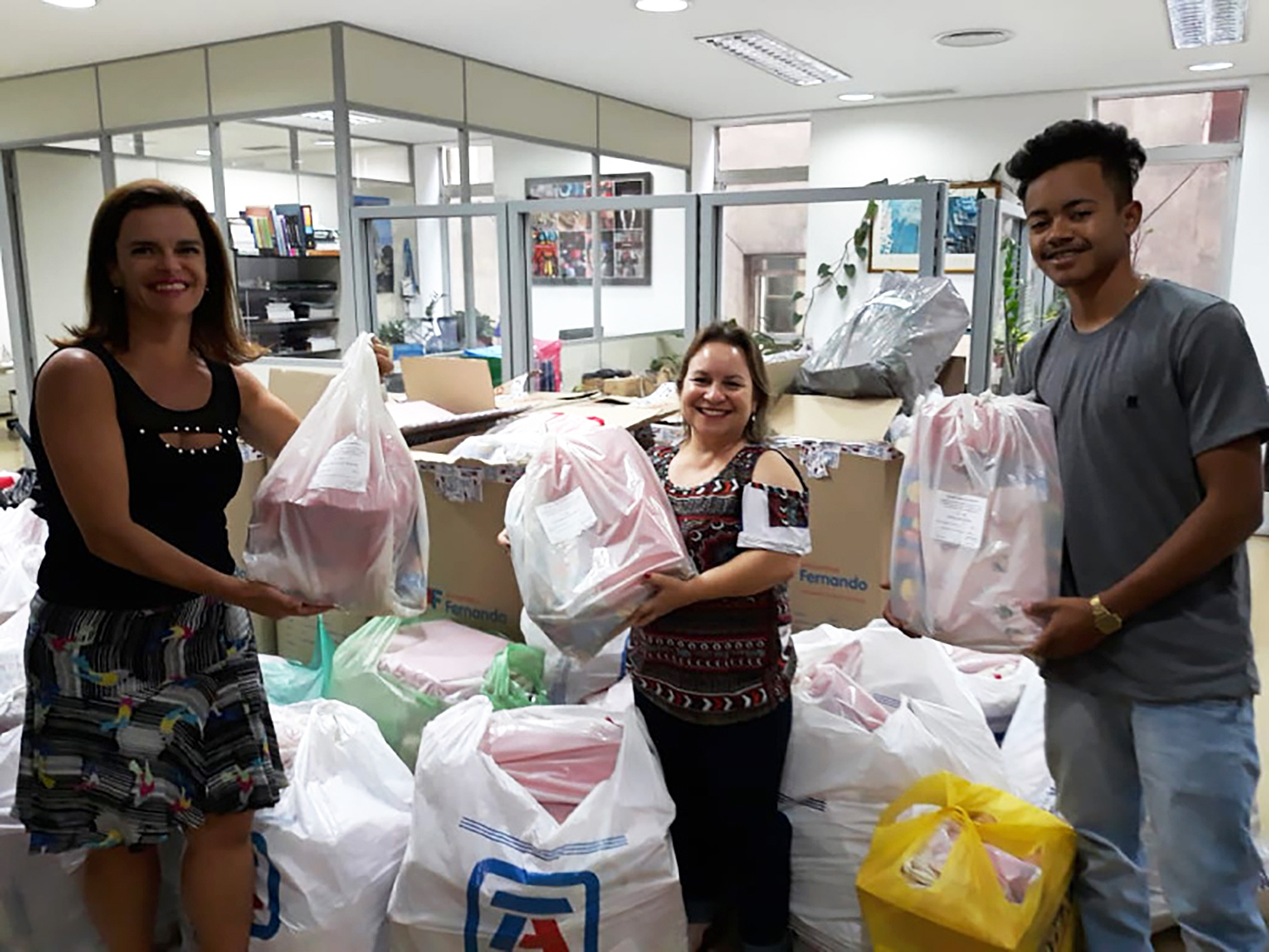 Colleagues in Brazil with Christmas bags for Grupo Amar