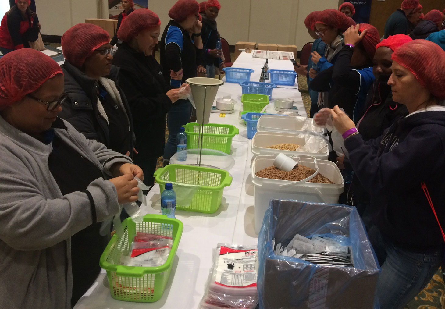 Colleagues packing meals for pre-school children for Rise against Hunger, on Mandela Day.