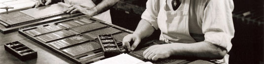 A black and white photo of a printing press at work