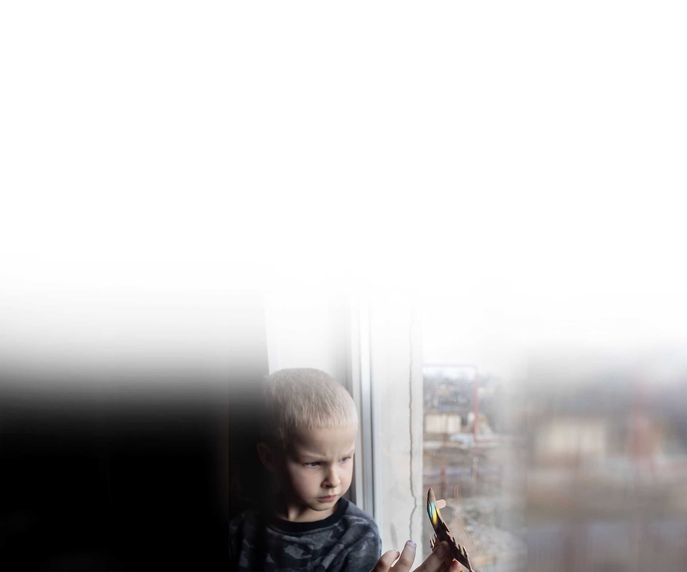 Boy looking out window