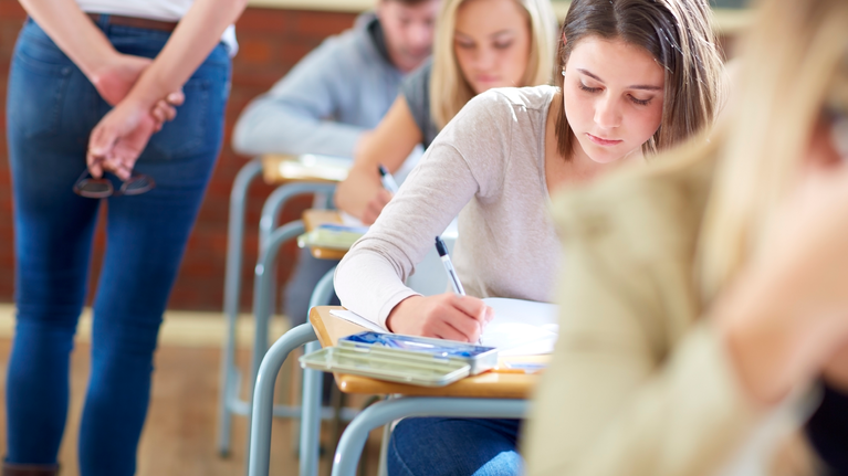 Teenage female student sat at desk during an exam