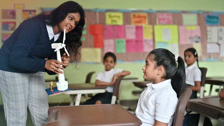 Teacher and pupils in classroom in a school in India.