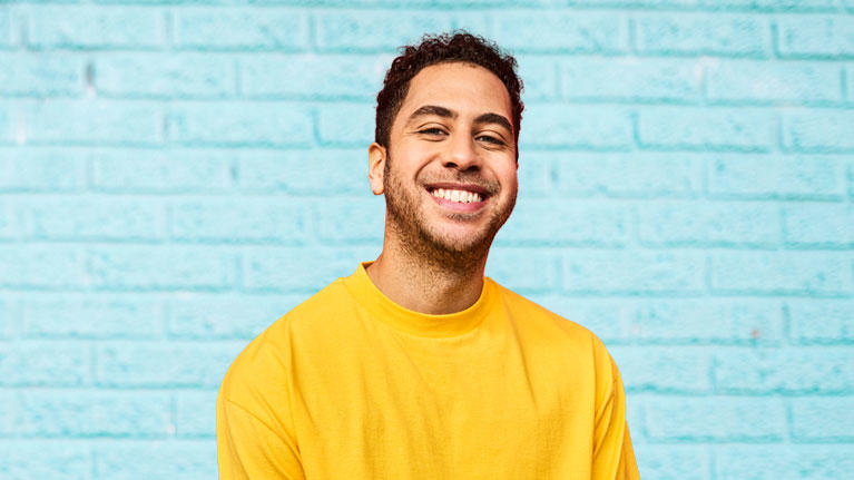 A young man smiling.