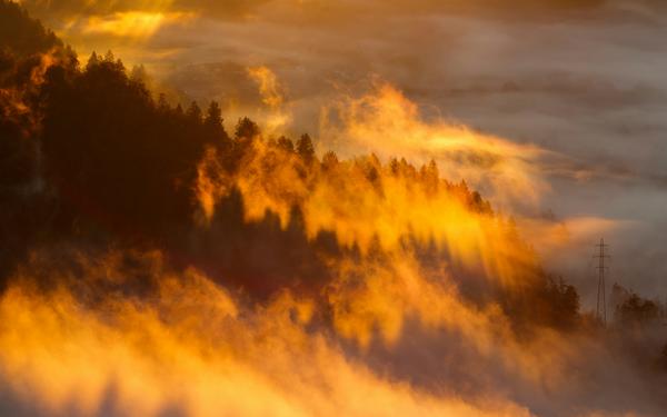 scene of orange clouds over mountains