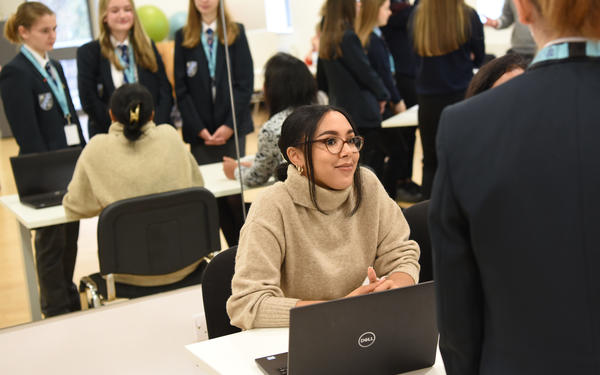 Cambridge colleague with school students during a careers carousel