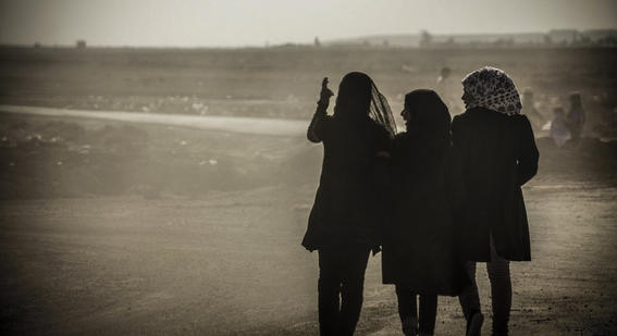 black and white photograph of the back of three women 