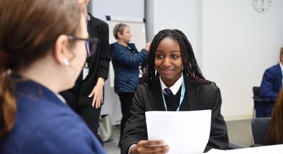 Student smiles while participating in mock interview event at Cambridge