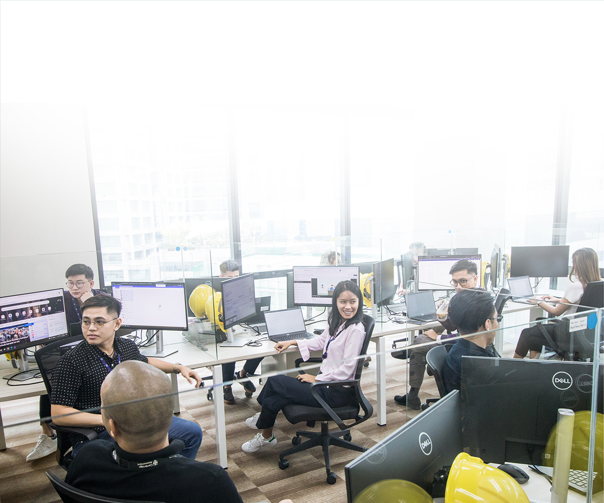 Colleagues in Manila sitting and working at their desks in the office