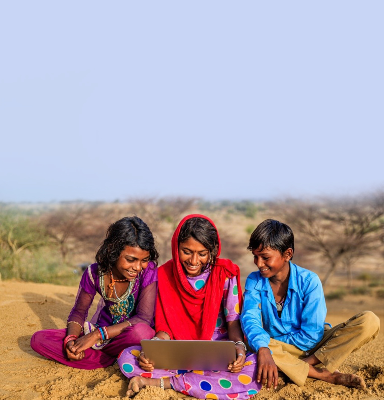 Children looking at screen together.