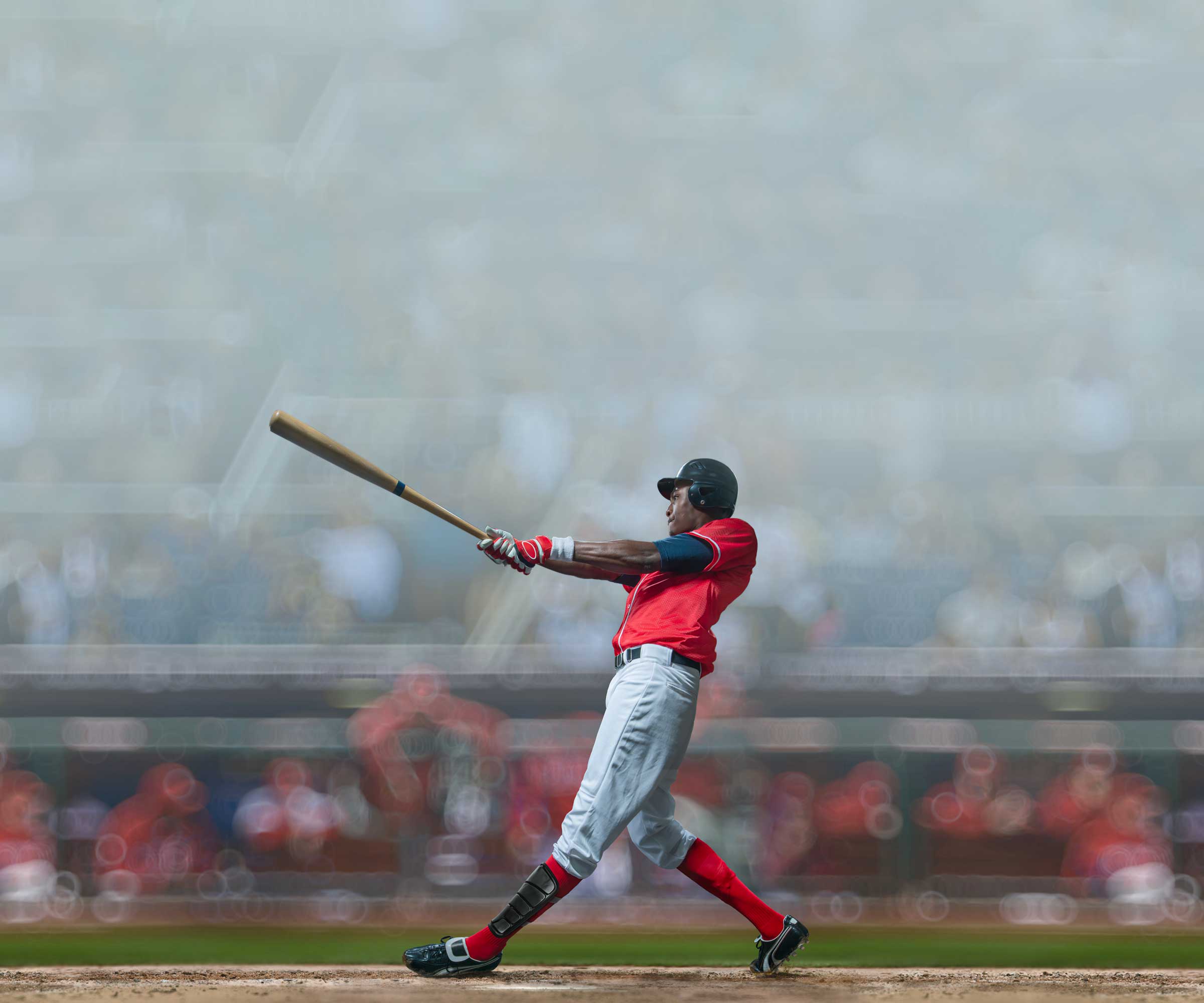 Baseball player hitting with bat